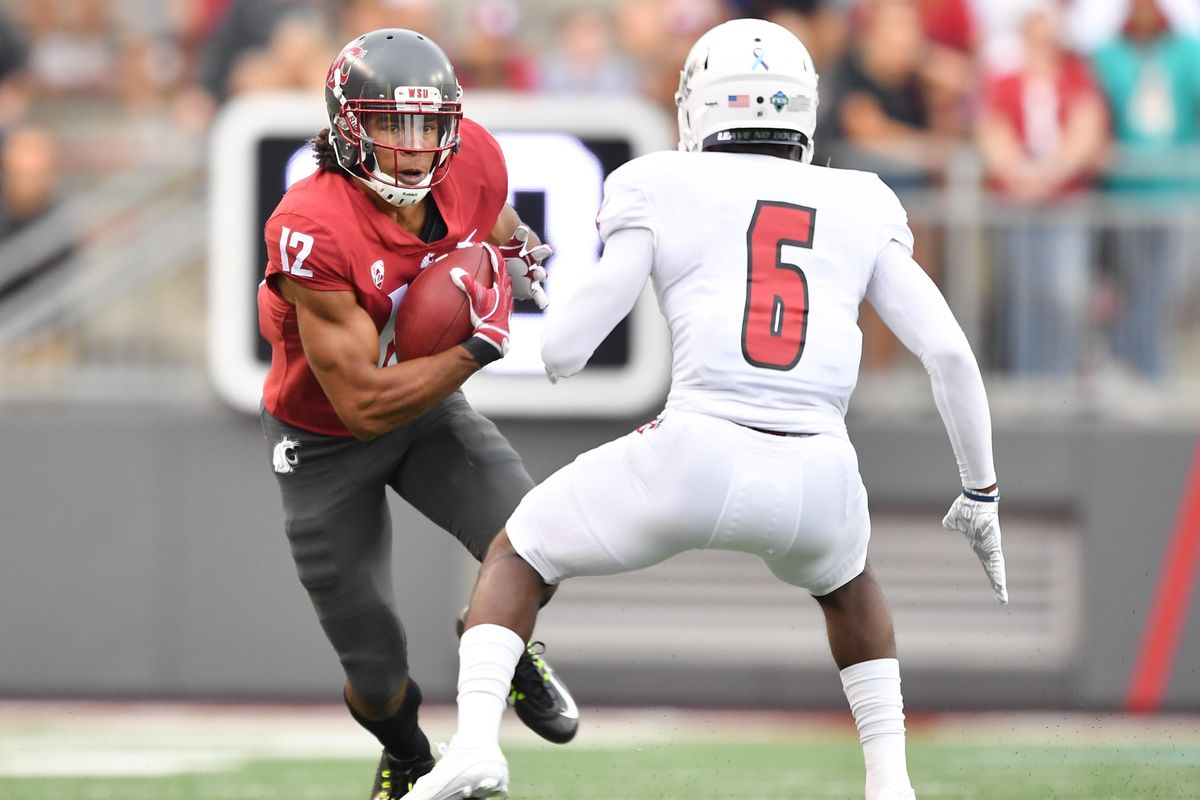 Washington State  wide receiver Dezmon Patmon  runs the ball against Eastern Washington  defensive back Nzuzi Webster  during the first half  Sept. 15 at Martin Stadium in Pullman. (Tyler Tjomsland / The Spokesman-Review)