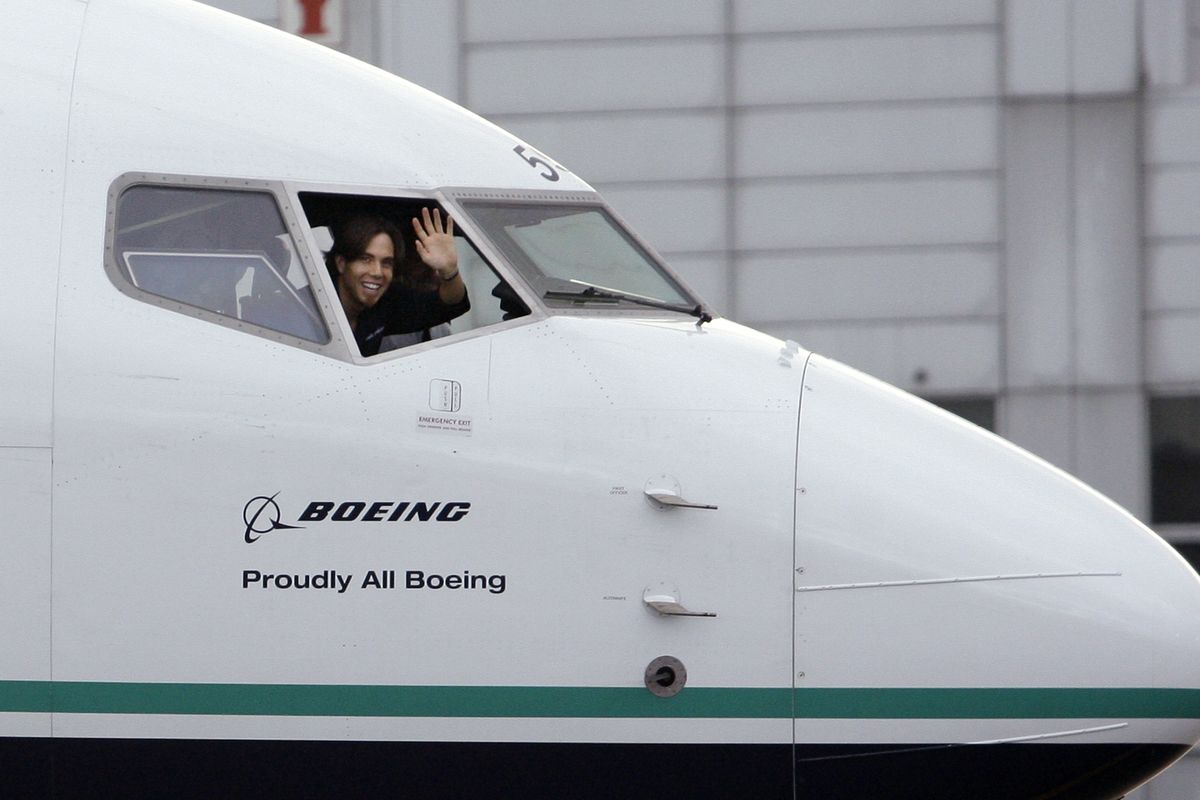 Olympic short-track speed skater Apolo Ohno waves from inside the cockpit of an Alaska Airlines jet as it arrives Tuesday at Seattle-Tacoma International Airport. The airline added the likeness of Ohno to the fuselage of the 737-800 in support of the skater’s bid for a gold medal in the 2010 Vancouver Games. Associated Press photos (Associated Press photos)