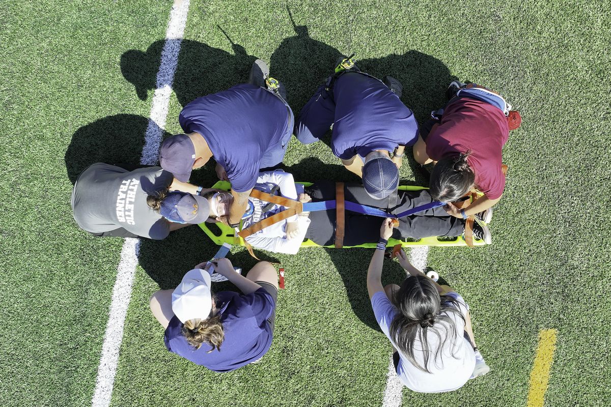 Members of the Mead High School athletic trainers program participate in a stretcher drill at Union Stadium. (Courtesy of Paul Grubbs)