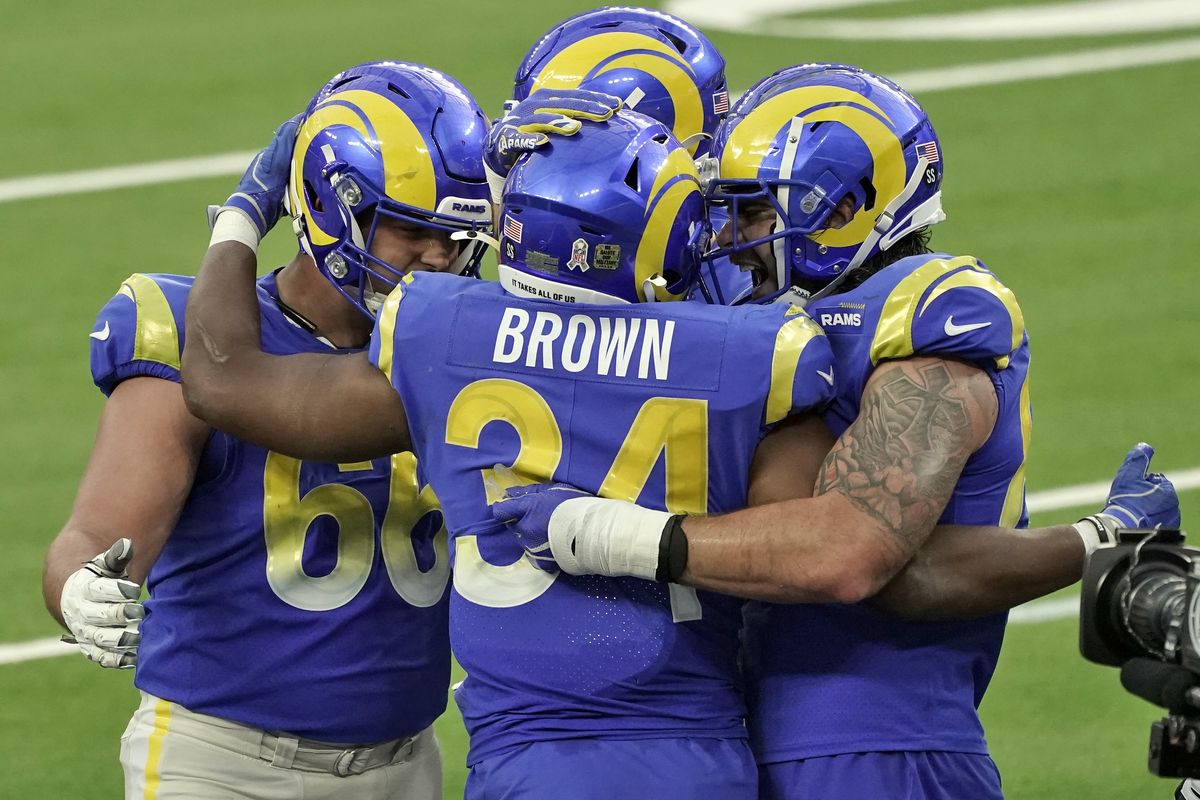 Los Angeles Rams running back Malcolm Brown (34) is hugged by teammates after scoring against the Seattle Seahawks during the second half of an NFL football game Sunday, Nov. 15, 2020, in Inglewood, Calif.  (Jae C. Hong)
