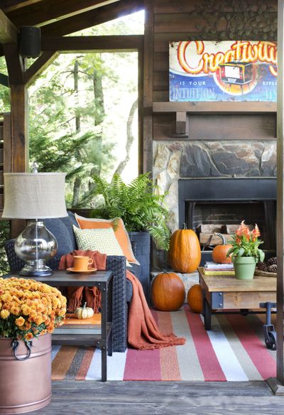 To ensure the outdoor living space of his mountain house stays warm and welcoming during the colder months, designer Brian Patrick Flynn chose woven blend upholstery, a wool and acrylic blend indoor-outdoor area rug and a wood-burning fireplace. (Associated Press)