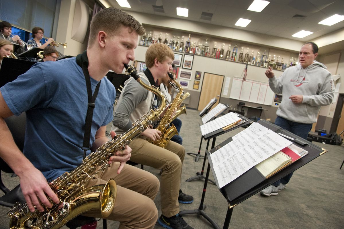 Ben Brueggemeier, right, leads Nick Beine, left, on sax, and the Ferris High School Jazz Orchestra during early morning practice Feb. 2 in the school’s band room. The jazz orchestra was selected to attend the Seattle Jazz Experience on March 13-14 at SeattleCenter. (PHOTOS BY DAN PELLE)