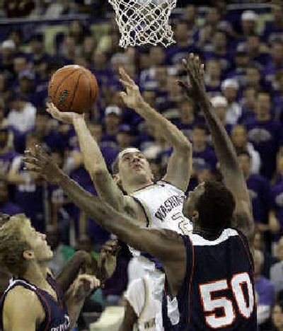 
Washington forward Hans Gasser puts up a shot. 
 (Associated Press / The Spokesman-Review)