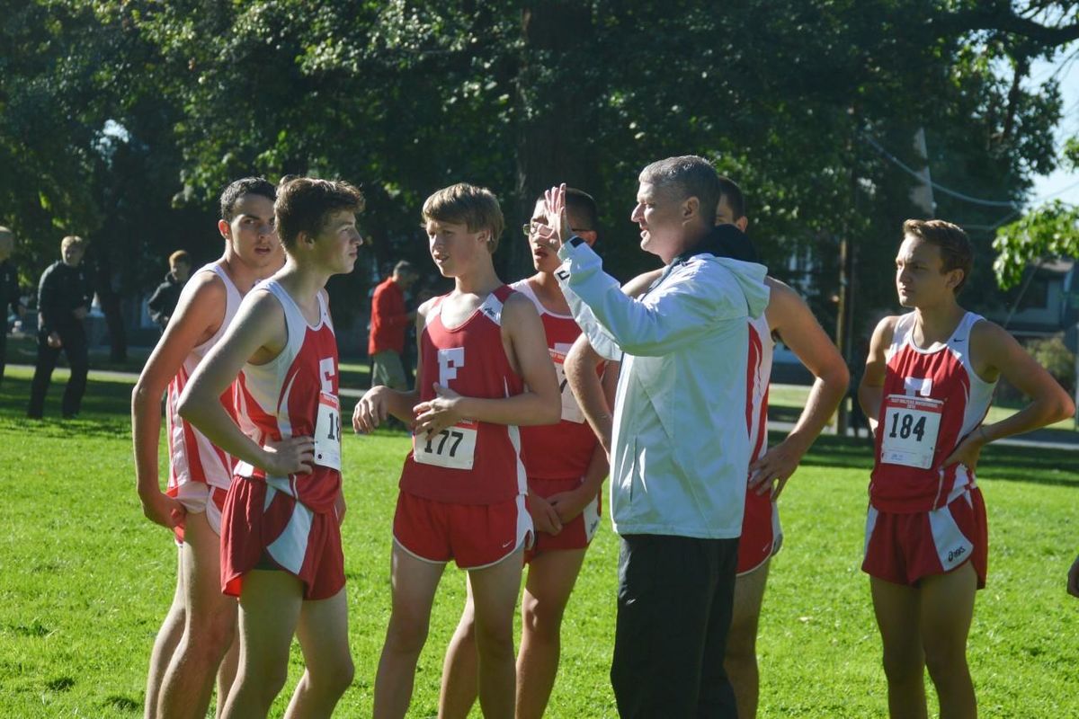 Chris Caviness, the boys cross country and girls track and field coach at Ferris, gives instructions to his team at a meet in 2019. Caviness died from cancer on Monday at 56. (Ferris athletics / Courtesy)