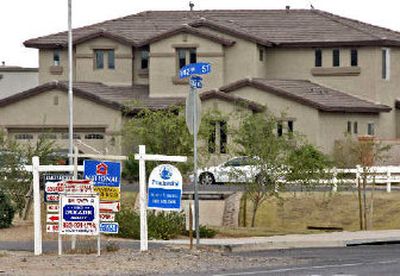 
For sale signs crowd a corner in Chandler, Ariz. A  group has charged that Zillow.com was misrepresenting home prices based on race. 
 (Associated Press / The Spokesman-Review)