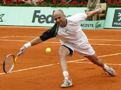 
American Andre Agassi, a first-round loser, stretches to return the ball to Finland's Jarkko Nieminen. 
 (Associated Press / The Spokesman-Review)