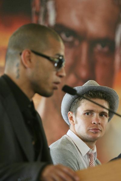 Junior middleweight champ Yuri Foreman, right, listens to Miguel Cotto speak during a news conference at Yankee Stadium in April. The soft-spoken kid whose parents told him to take up boxing after bullies beat him up, became the first orthodox Jew to win a world championship in nearly 75 years. His name will be on the marquee next month for the first fight at Yankee Stadium in more than three decades, when he defends his junior middleweight title against Cotto.  (Associated Press)