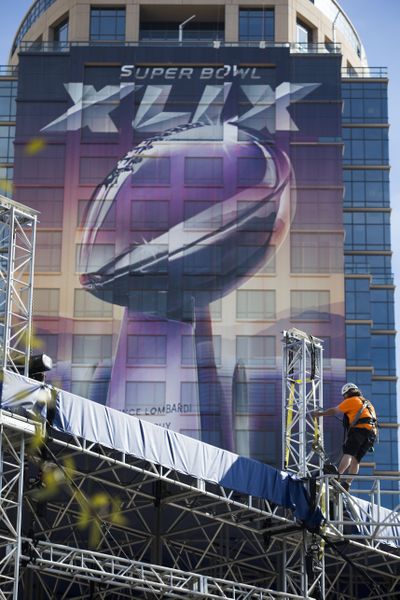 Back in the desert, breakdown crews worked on cleaning up after the Super Bowl. (Associated Press)