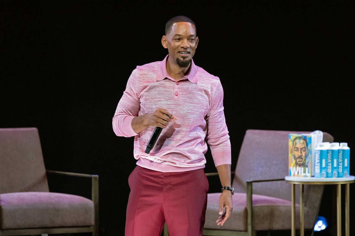 Will Smith pauses during an appearance with Mark Manson while on tour to promote his new book "Will" on Wednesday at the Chicago Theatre in Chicago.   (Rob Grabowski/Invision/AP)