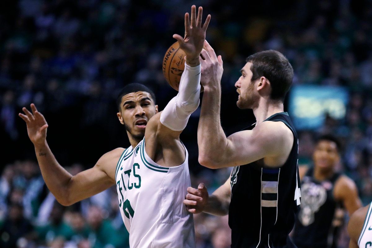 Boston Celtics forward Jayson Tatum, left, pressures Milwaukee Bucks center Tyler Zeller, right, during the first quarter of Game 2 of an NBA basketball first-round playoff series in Boston, Tuesday, April 17, 2018. (Charles Krupa / Associated Press)