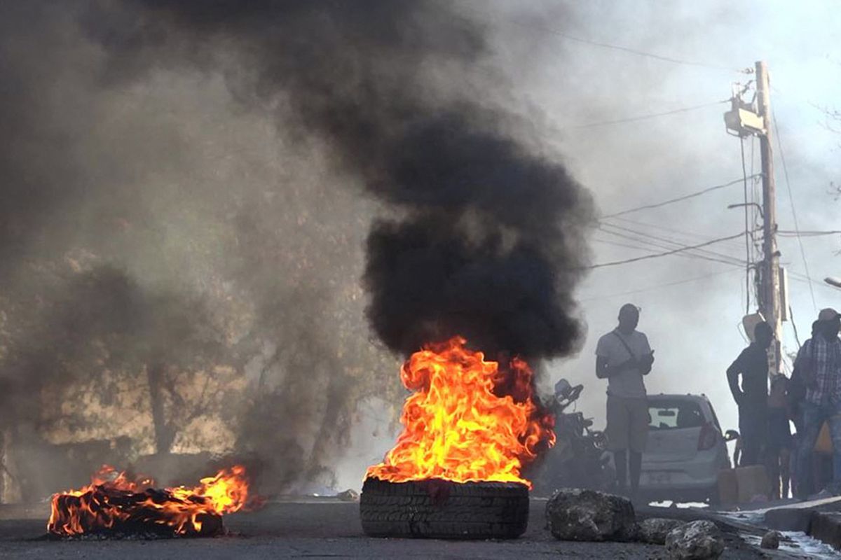 This screen grab taken from AFPTV shows tires on fire near the main prison of Port-au-Prince, Haiti, on March 3, 2024, after a breakout by several thousand inmates.    (Luckenson Jean/AFPTV/AFP/Getty Images/TNS)