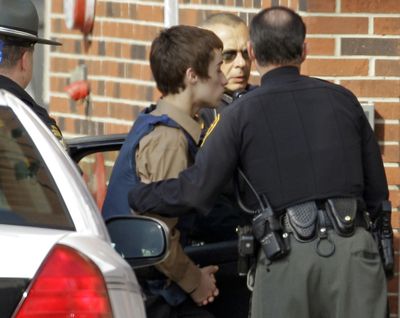 T.J. Lane, a suspect in Monday’s shooting of five students at Chardon High School is taken into juvenile court by Geauga County deputies in Chardon, Ohio, on Tuesday. (Associated Press)