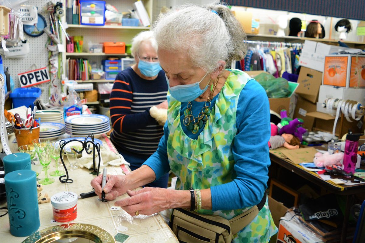 Christina Thompson, president of the Colfax Thrifty Grandmothers Club, writes out a price label Friday at the Thrifty Grandmothers Shop on South Main Street.   (Greg Mason / The Spokesman-Review)