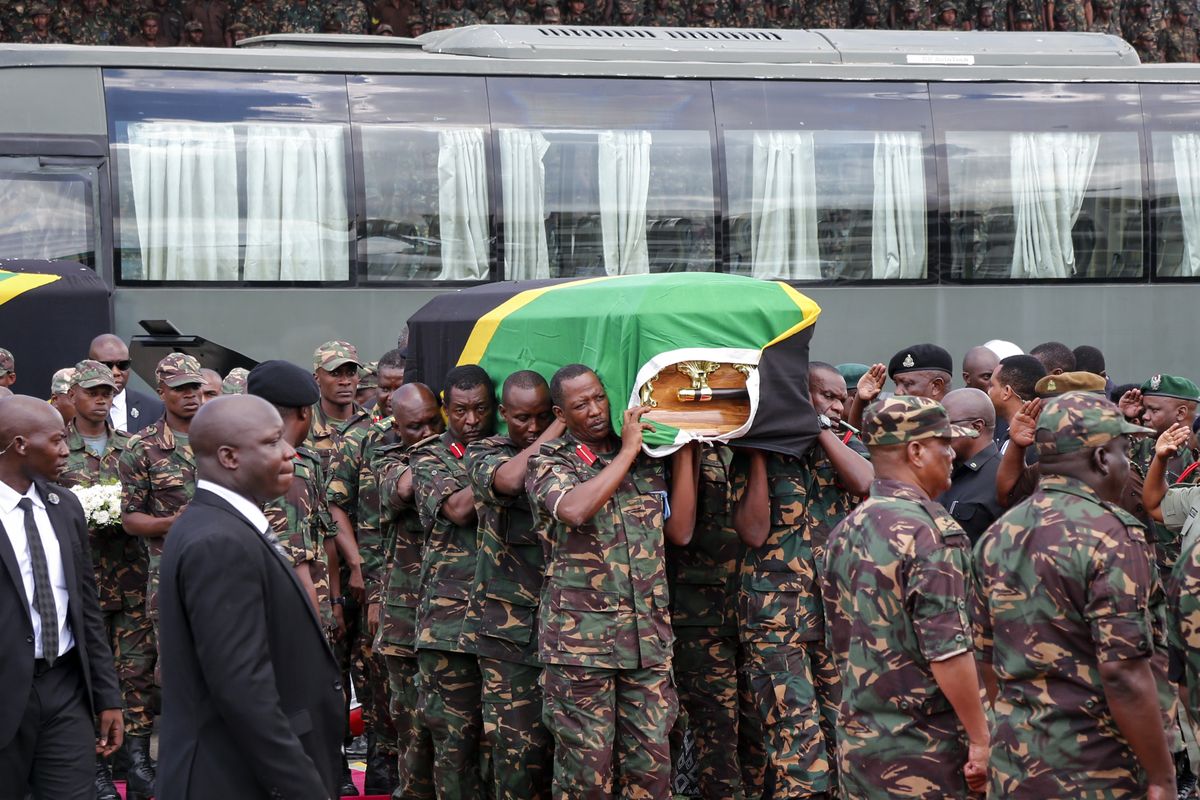 Members of the military carry the body of former president John Magufuli to lie in state at Uhuru stadium in Dar es Salaam, Tanzania Saturday, March 20, 2021. Magufuli, a prominent COVID-19 skeptic whose populist rule often cast his country in a harsh international spotlight, died Wednesday aged 61 of heart failure, it was announced by Vice President Samia Suluhu Hassan, who was sworn-in as the country