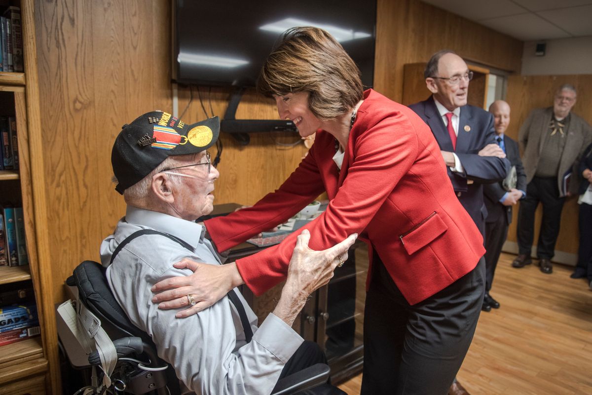 Congresswoman Cathy McMorris Rodgers embraces WWII Army veteran Mike Olmstead, 99 years old, and thanks him for his service during her visit to the Mann-Grandstaff VA Medical Center Friday, Nov. 17, 2017, in Spokane, Wash. Congressman Dr. Phil Roe, Chairman of the House Committee on Veterans Affairs, stands behind McMorris Rodgers at right.   (DAN PELLE/THE SPOKESMAN-REVIEW)
