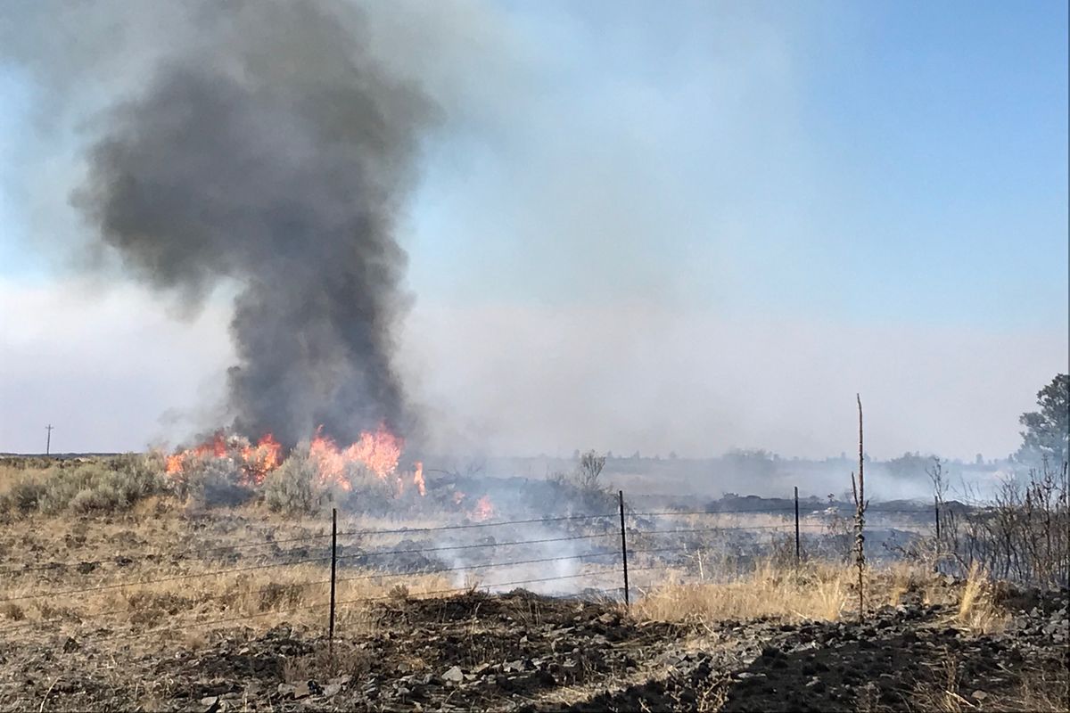 Fire erupts in sagebrush just off U.S. Highway 2 on the eastern edge of the 130,000-acre Whitney Fire west of Davenport. There are unfounded rumors circulating on social media that antifa is starting wildfires in the West.  (THOMAS CLOUSE/The Spokesman-Review)
