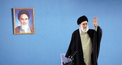 
Iran's supreme leader, Ayatollah Ali Khamenei, waves to laborers in Tehran  on Wednesday. Khamenei said  that Iran would attack U.S. targets around the world in the event it is attacked. 
 (Associated Press / The Spokesman-Review)