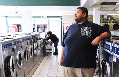 Herbert Smith, 31, waits for clothes to be finished Monday at a laundromat in Washington, D.C., that is frequented by the less-well-to-do. Recent studies show that those who make less tend to give a larger percentage of their income to charity and in tough economic times richer Americans tend to cut back on charitable donations more. McClatchy Tribune (McClatchy Tribune / The Spokesman-Review)