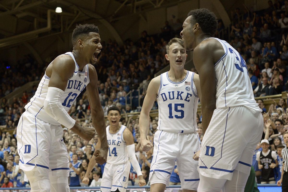 Duke freshmen players Javin DeLaurier (12), Jordan Goldwire (14), and Alex O