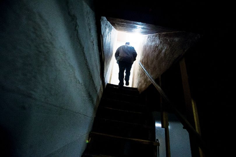 John Padula, president of Set Apart Discipleship, ascends the stairs from the basement area of the Coeur d'Alene faith-based rehabilitation facility. The organization is hoping to expand their services by finishing the basement of the Sixth Street home which would allow for more beds. (Shawn Press)