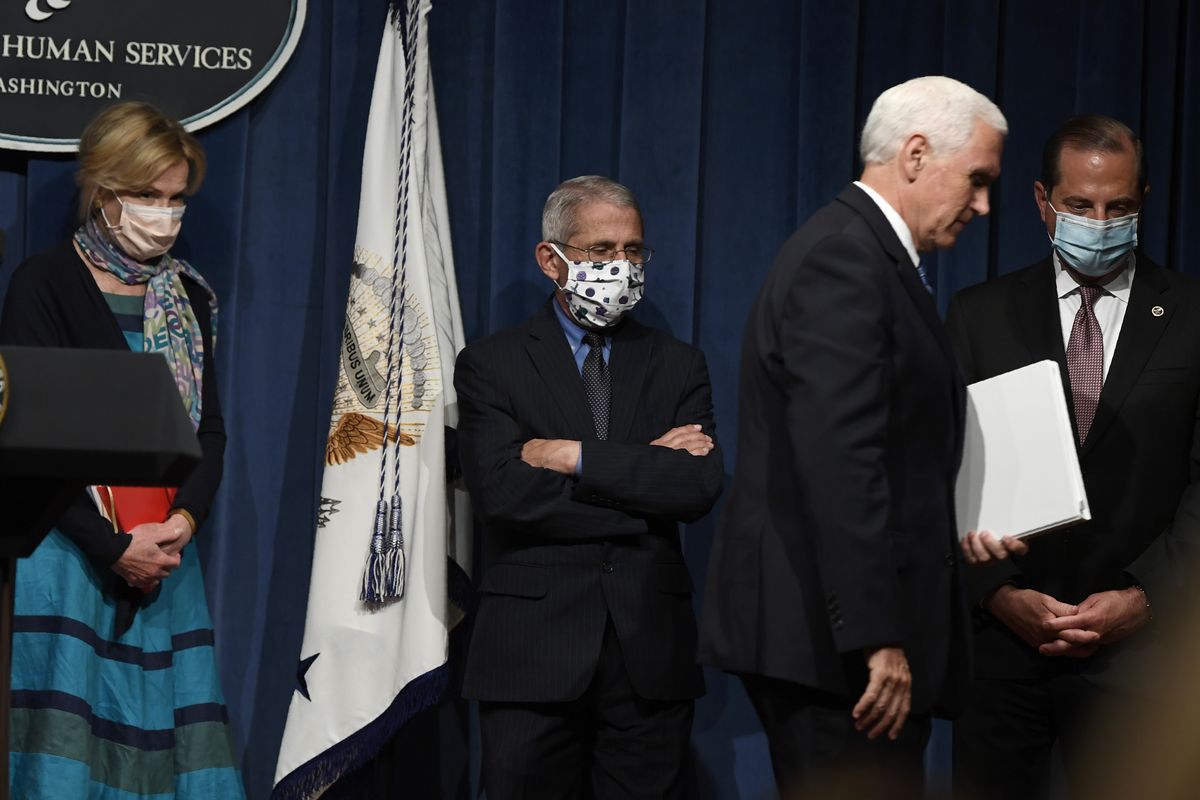 FILE - In this June 26, 2020, file photo Vice President Mike Pence, second from right, walks off of the stage following the conclusion of a briefing with the Coronavirus Task Force at the Department of Health and Human Services in Washington. Dr. Deborah Birx, left, Dr. Anthony Fauci, second from left, and Health and Human Services Secretary Alex Azar, right, follow Pence. On Friday, Pence said Americans should look to their state and local leadership for modeling their behavior. The comments only days after President Donald Trump held two campaign events that drew hundreds of participants but few wearing masks.  (Susan Walsh)