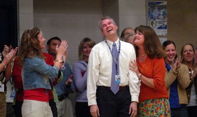 
Spanish teacher Mike Nelson, center, stands among his fellow teachers, incredulous at being announced as the recipient of a Milken Family Foundation award for teaching Wednesday during an assembly at Coeur d'Alene High School. The award comes with a $25,000 award and a trip to Washington, D.C. next spring. 
 (Jesse Tinsley / The Spokesman-Review)