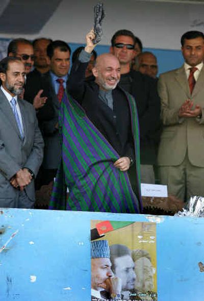
Afghan President Hamid Karzai waves to his supporters during a campaign stop Wednesday at the Kabul stadium. 
 (Associated Press / The Spokesman-Review)