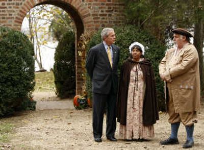 
President Bush talks with Jim Curtis and Mattie Jones, dressed in period costumes, at the Thanksgiving Shrine at Berkeley Plantation in Charles City, Va., Monday. Associated Press
 (Associated Press / The Spokesman-Review)
