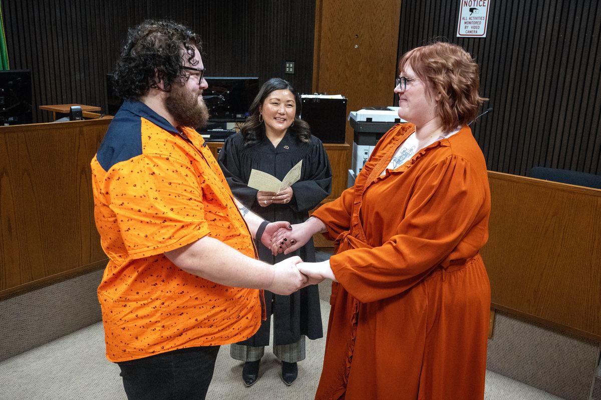Spokane County District Court Judge Aimee Maurer marries Megan Wicks and Alex Bartunek during a Friday the 13th wedding ceremony at the Public Safety building. Nine other couples tied the knot during a slew of civil ceremonies Friday evening.  (COLIN MULVANY/THE SPOKESMAN-REVIEW)