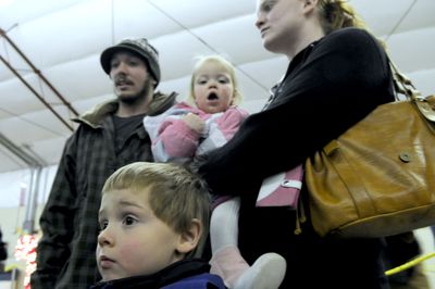 Casey and Ashley Coulter, and their son Elijah, 4, and daughter Neveah, 18 months, visit the Christmas Bureau on Monday.  (Kathy Plonka / The Spokesman-Review)