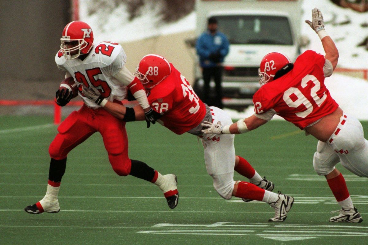 In this Dec. 13, 1997 file photo, Eastern Washington’s Jarrad Jeske and Derek Strey, right, try to bring down Youngstown State running back Demetrius Harris during an NCAA Division 1-AA semifinal game Saturday, Dec. 13, 1997, in Spokane. (FILE / The Spokesman-Review)