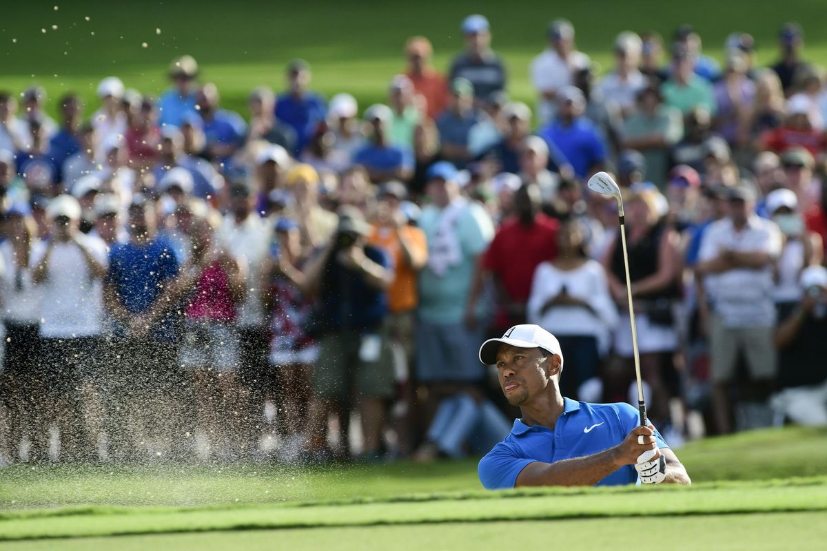 Tiger Woods hits out of the sand to the 15th green during the third round of the Tour Championship golf tournament Saturday, Sept. 22, 2018, in Atlanta. (John Amis / Associated Press)