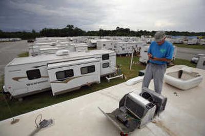 
Maintenance worker Don Kehoe  makes a call from the top of a FEMA trailer  in Baker, La.  The federal agency has said it will test for formaldehyde in trailers still occupied by Katrina survivors.Associated Press
 (Associated Press / The Spokesman-Review)