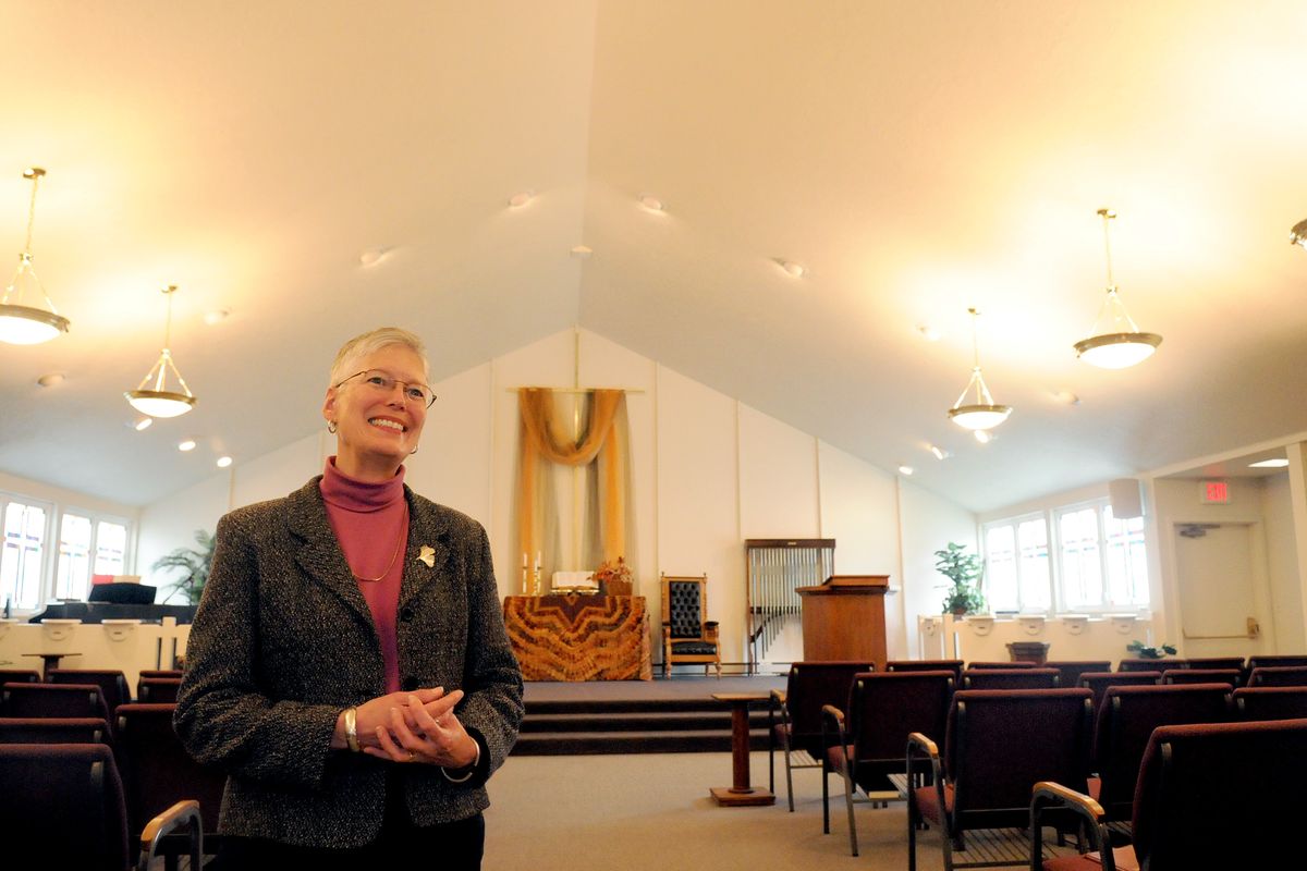 Rev. Linda Crowe stands in the sanctuary of Veradale United Church of Christ, recently, where she has been the pastor for 16  years. The church is celebrating 100 years of service. (Jesse Tinsley)