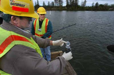 
Scott Austin, left, caps a water sample fished out of the Spokane River by Gary Bussiere on Wednesday. Scott Austin, left, caps a water sample fished out of the Spokane River by Gary Bussiere on Wednesday. 
 (Christopher Anderson/Christopher Anderson/ / The Spokesman-Review)
