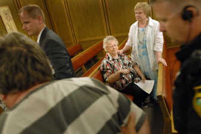 
Betty Halligan, center, is comforted by her daughter- in-law Gail Halligan Tuesday as her son, Michael, is led to prison after he and his girlfriend pleaded guilty to 14 felony counts. 
 (Brian Plonka / The Spokesman-Review)