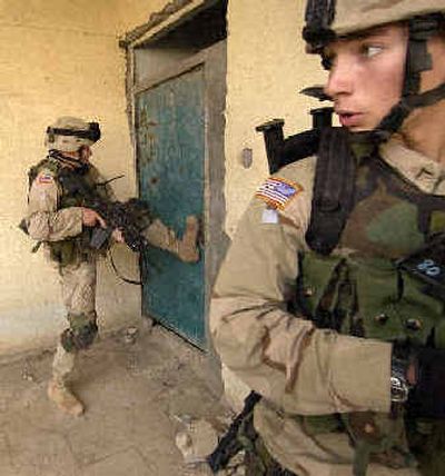 
U.S. soldiers search a building for rebels suspected of planting a roadside bomb in Mosul on Sunday. 
 (Associated Press / The Spokesman-Review)