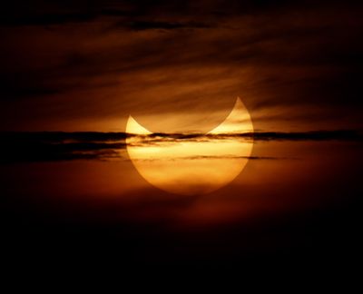 An annular solar eclipse is partially seen at sunrise Monday, May 21, 2012, from the coastal township of Gumaca, Quezon province, 187 kilometers (116 miles) southeast of Manila, Philippines. Millions of Asians watched as a rare
