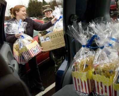 
Liz Edmondson, left,  and Senior Airman Robin Kinney  load gift bags for local families of deployed troops into Edmondson's vehicle  Thursday at Fairchild Air Force Base.  Edmondson, a volunteer with Operation Spokane Heroes, is spending this holiday without her husband, who is stationed in Iraq. 
 (Ingrid Lindemann / The Spokesman-Review)