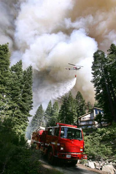 
Firefighters work to save homes near South Lake Tahoe on Sunday.Associated Press
 (Associated Press / The Spokesman-Review)