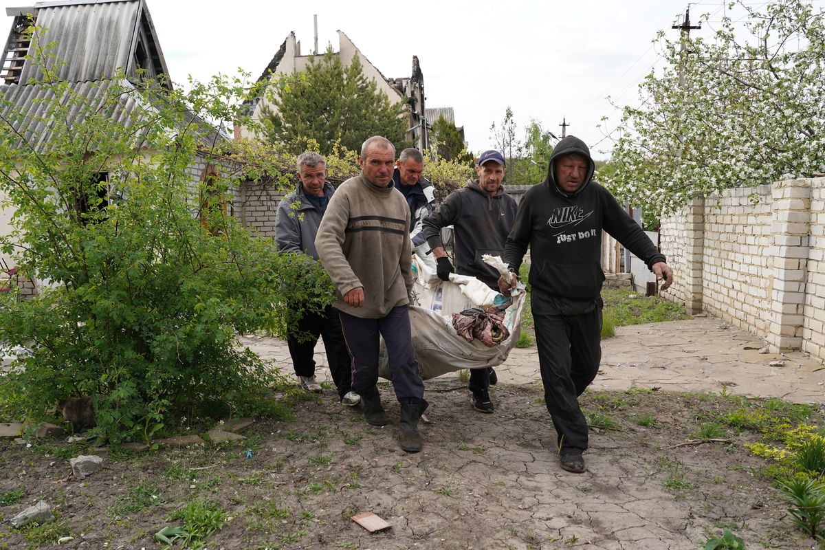 Volunteers exhume the bodies of civilians killed by Russian shelling in the village of Stepaky, close to Kharkiv, Ukraine, Wednesday, May 11, 2022.  (Andrii Marienko)