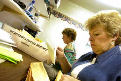 
Sharon Vega, right, stuffs ballots into envelopes Thursday at the Kootenai County Elections office in Coeur d'Alene. At left is Fran Vradenburg. Vega is in charge of mailing out thousands of absentee ballots requested for this November's election in Kootenai County. 
 (Jesse Tinsley / The Spokesman-Review)
