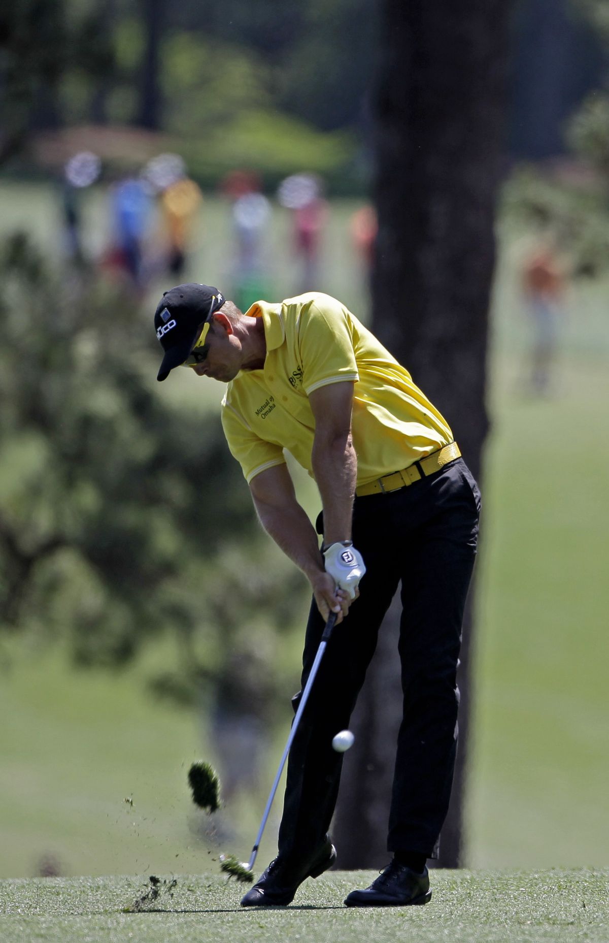 Henrik Stenson, hitting off the first fairway, is five strokes behind leader Peter Hanson. (Associated Press)