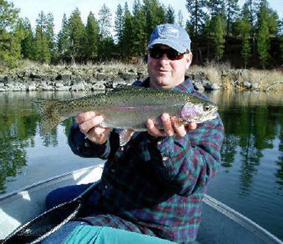 
Chris Donley, Washington Department of Fish and Wildife district fisheries biologist, displays a healthy rainbow trout he caught and released at Amber Lake in March. 
 (Boyd Matson photo / The Spokesman-Review)