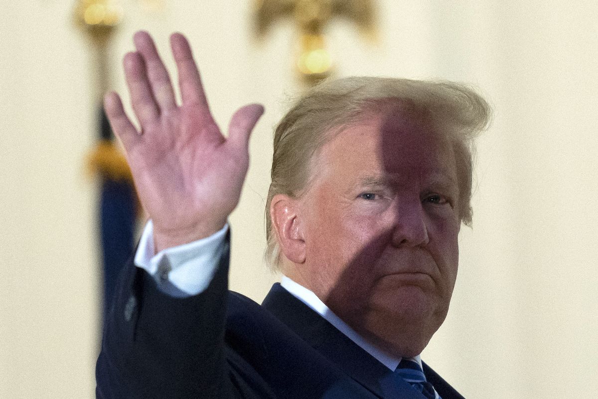 President Donald Trump waves from the Blue Room Balcony upon returning to the White House Monday, Oct. 5, 2020, in Washington, after leaving Walter Reed National Military Medical Center, in Bethesda, Md. Trump announced he tested positive for COVID-19 on Oct. 2.  (Alex Brandon)