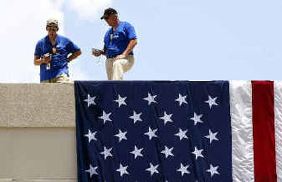 BioONE staff use electronic devices atop the former American Media Inc. building Sunday in Boca Raton, Fla.
(Associated Press / The Spokesman-Review)
