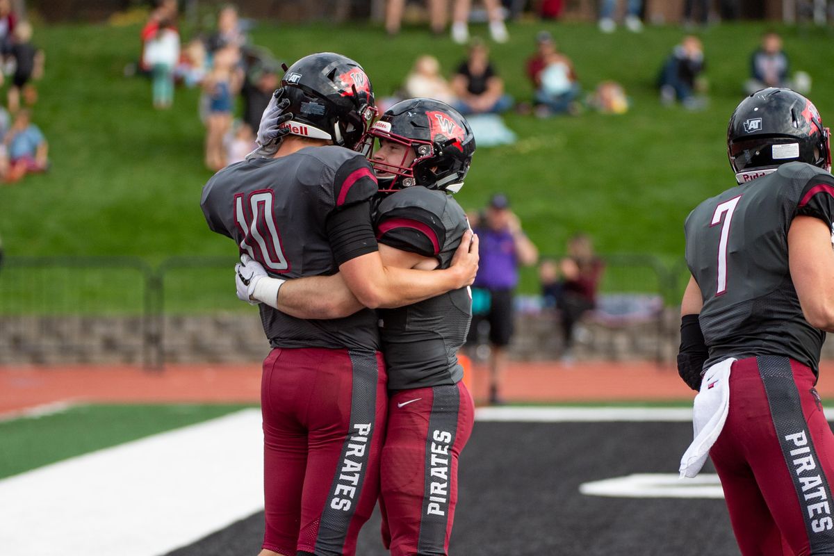 Whitworth quarterback Leif Ericksen (10) celebrates his 22-yard touchdown  run with teammate Mason Elms  against Linfield College on Sept. 29 at the  Pine Bowl. (Libby Kamrowski / The Spokesman-Review)