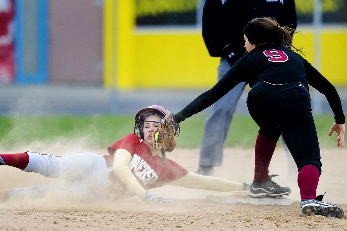 University’s Rachael Johnson slides safely into second base, avoiding a tag attempt by North Central shortstop Lauren Hare. (Tyler Tjomsland)