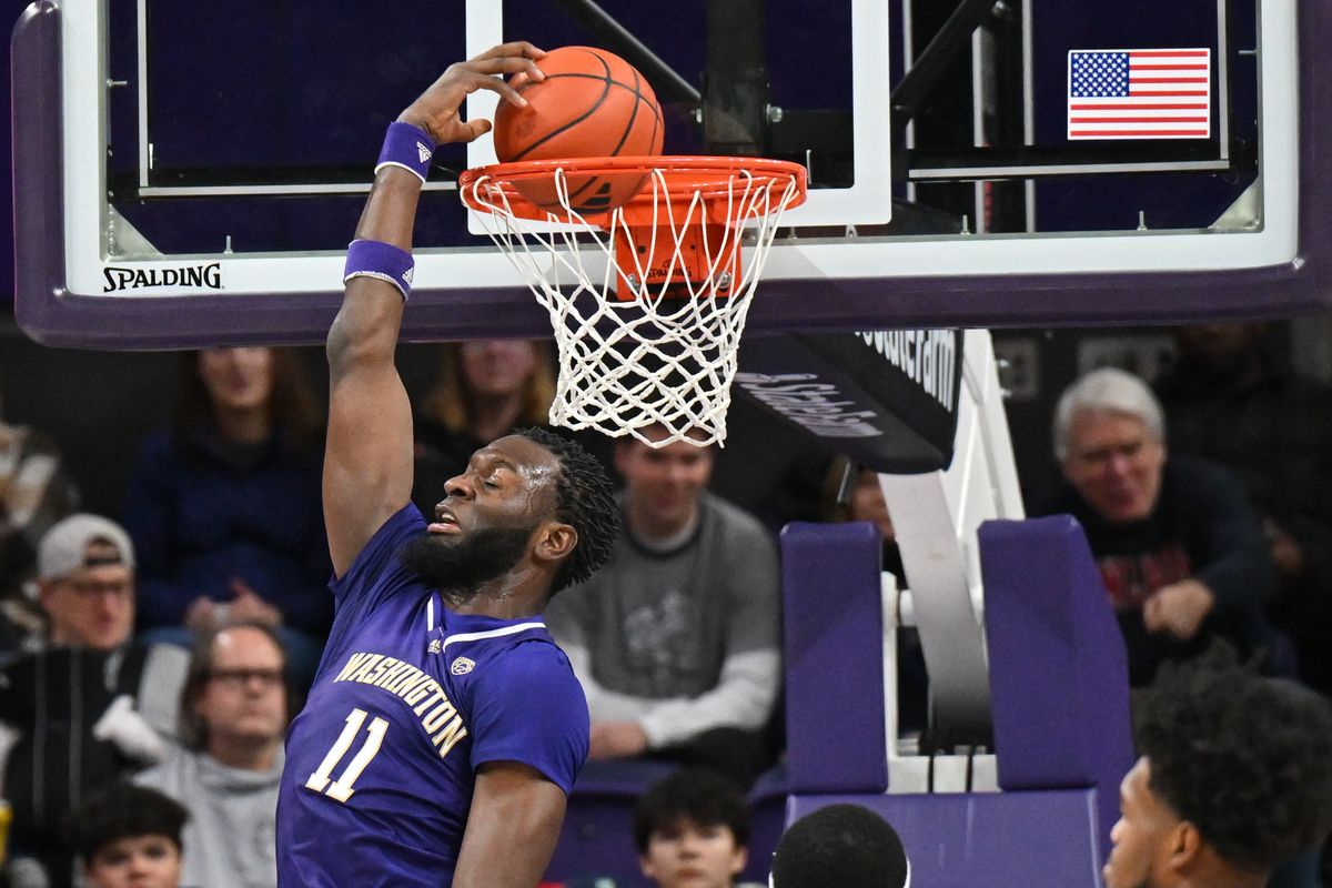 Washington Huskies center Franck Kepnang (11) reverses the ball into the hoop agianst Gonzaga during the first half of a college basketball game on Saturday, Dec. 9, 2023, at Alaska Airlines Arena at Hec Edmundson Pavilion in Seattle, Wash.  (TYLER TJOMSLAND/THE SPOKESMAN-REVIEW)