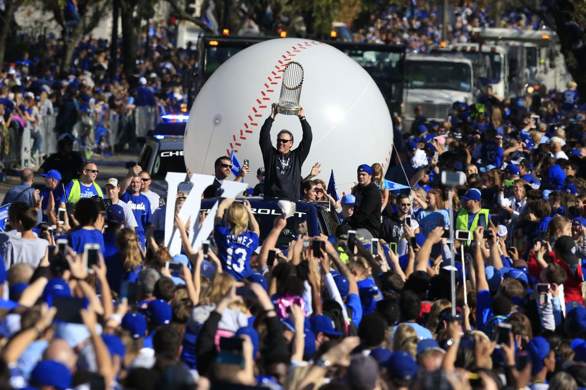 Kansas City Royals manager Ned Yost holds the World Series trophy during a victory parade in Kansas City, Mo. on Tuesday. (Associated Press / Associated Press)